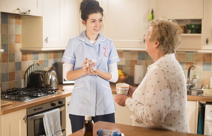 senior woman chats to care worker